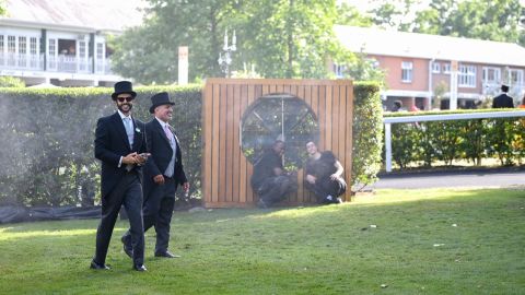 Racegoers cool off in the heat during Royal Ascot 2022 as a heatwave hits Western Europe. 