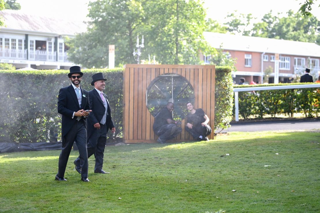 Racegoers cool down in the heat during Royal Ascot 2022 as a heatwave hits western Europe. 