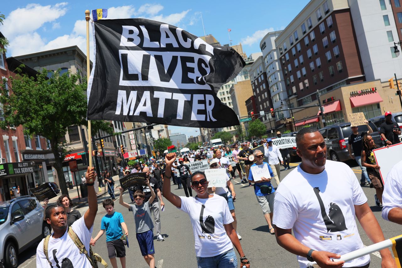 People march in a Juneteenth reparations rally in Newark, New Jersey on Friday. Rally-goers called on New Jersey lawmakers to pass legislation to establish a Reparations Task Force to propose policy for reparative justice.