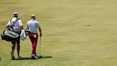 Thomas walks with caddie Jim 'Bones' Mackay up the third fairway.