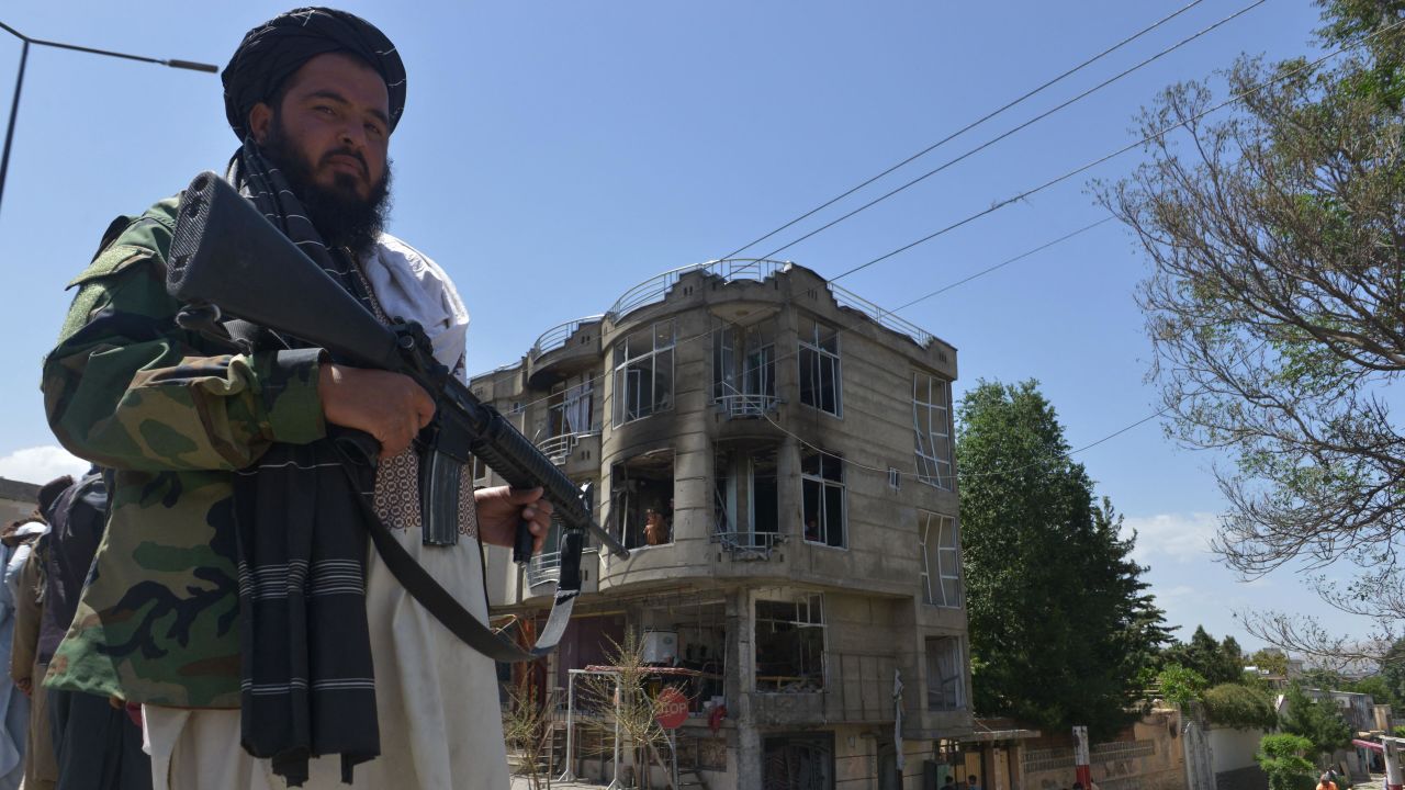 A Taliban fighter guards a Sikh temple following an attack by gunmen in Kabul on June 18, 2022.