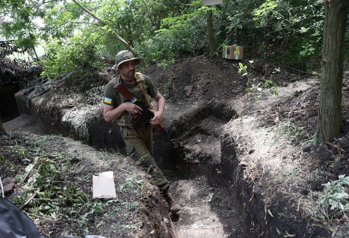 A Ukrainian serviceman walks along an entrenched position on the front line near Avdiivka, Donetsk region on June 18/