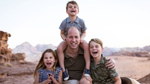 Prince William poses with his children, (from left to right) Princess Charlotte, Prince Louis and Prince George, in a photograph taken in Jordan and shared on June 19 for Father's Day. 