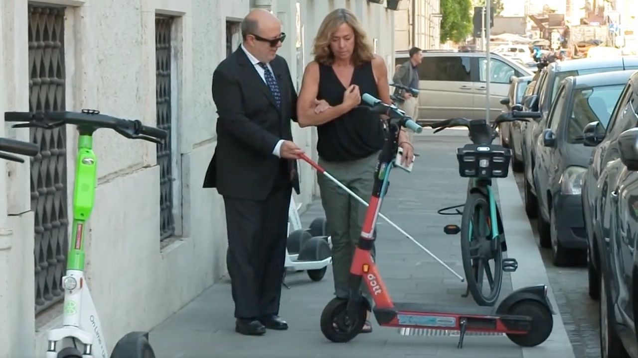 Giuliano Frittelli, left, wants it to be mandatory for scooters to be parked in designated places.