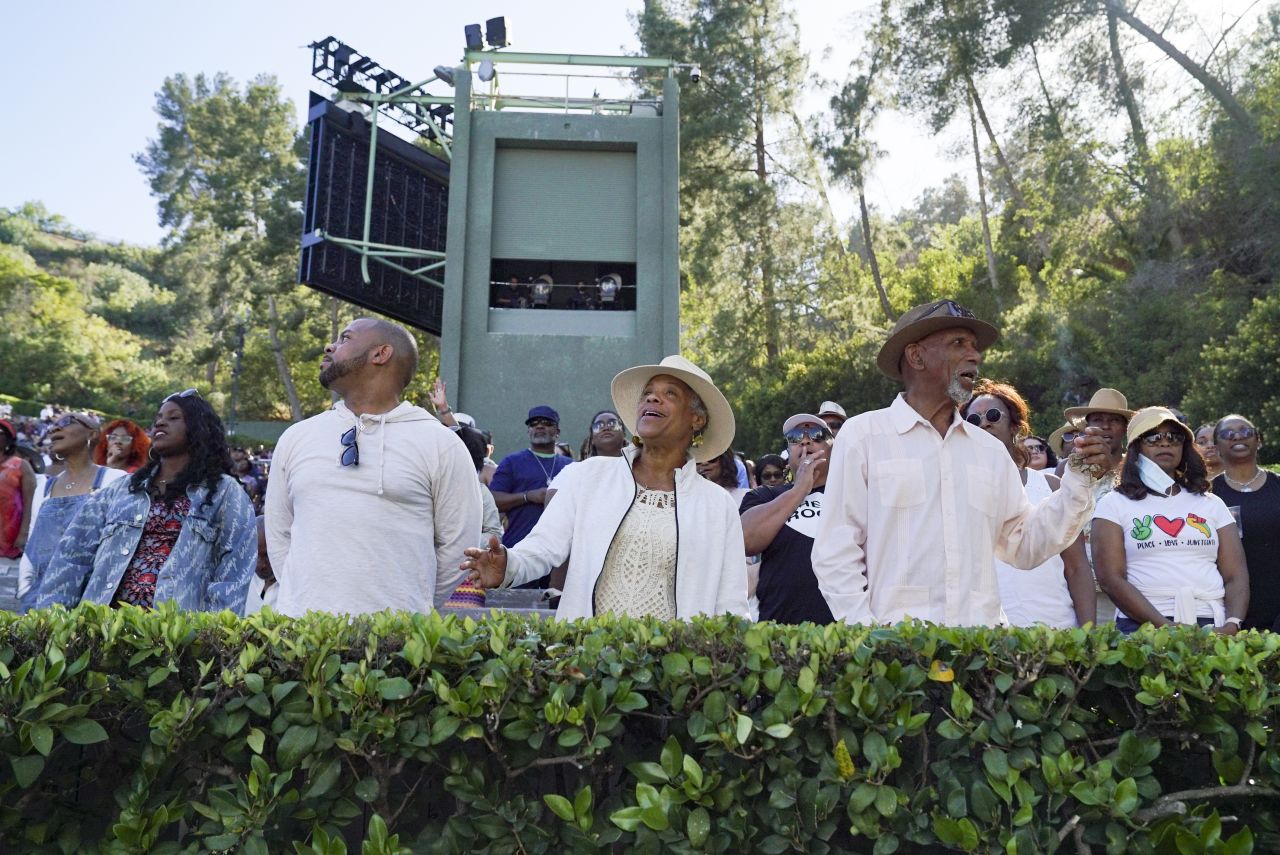 Audience members stand as "Let Freedom Ring" plays during the Juneteenth celebration at the Hollywood Bowl in Los Angeles on Sunday.