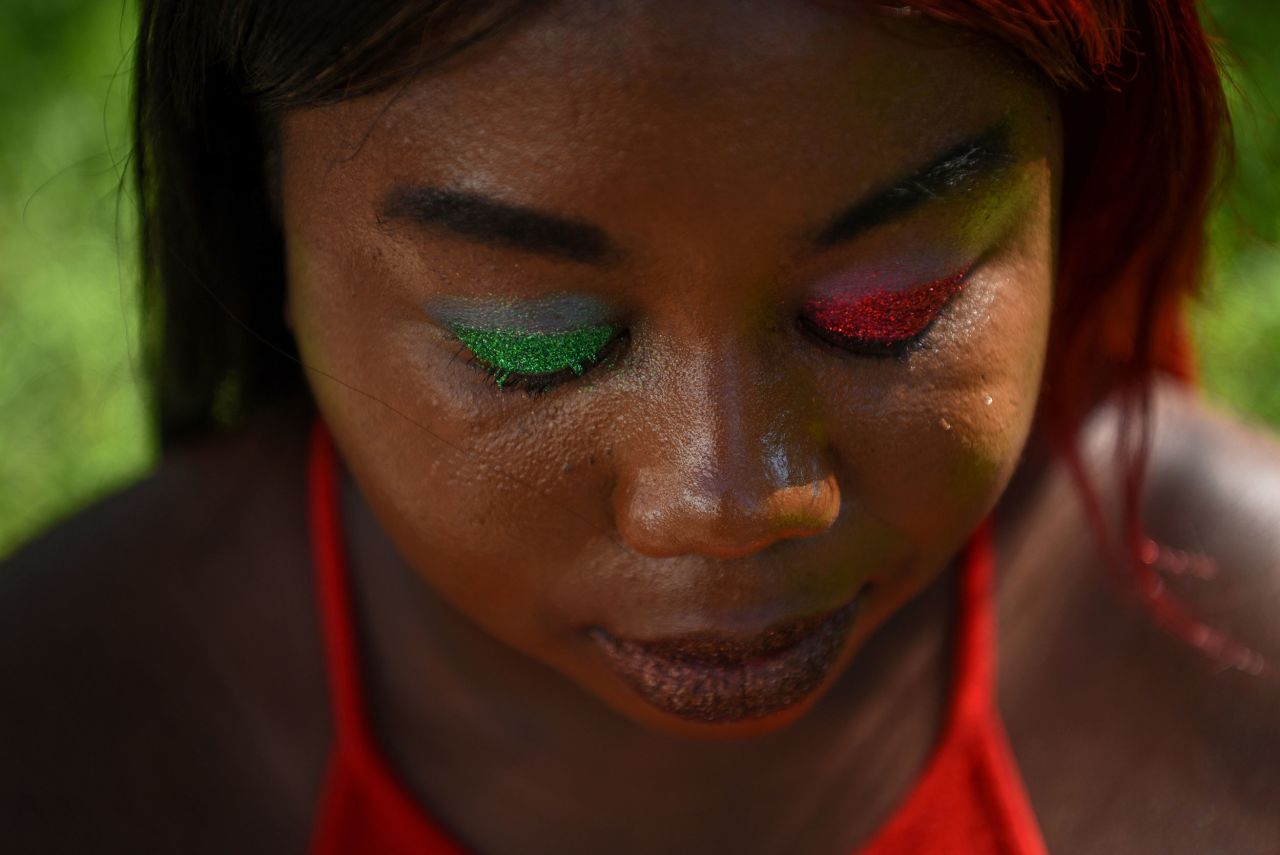 Tasheanna Jones wears festive eyeshadow while posing for a portrait at a Juneteenth celebration in Galveston, Texas, on Sunday.