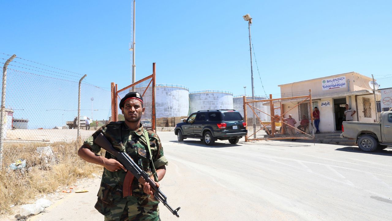 A member of the Petroleum Facilities Guard is seen at the entrance of Azzawiyah Oil Refinery, in Zawiyah west of Tripoli, Libya July 23, 2020. 