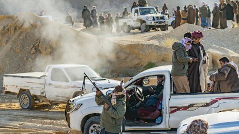 A man celebrates the end of the Wadi Zalaga annual camel race by shooting with a rifle in Sinai, Egypt.
