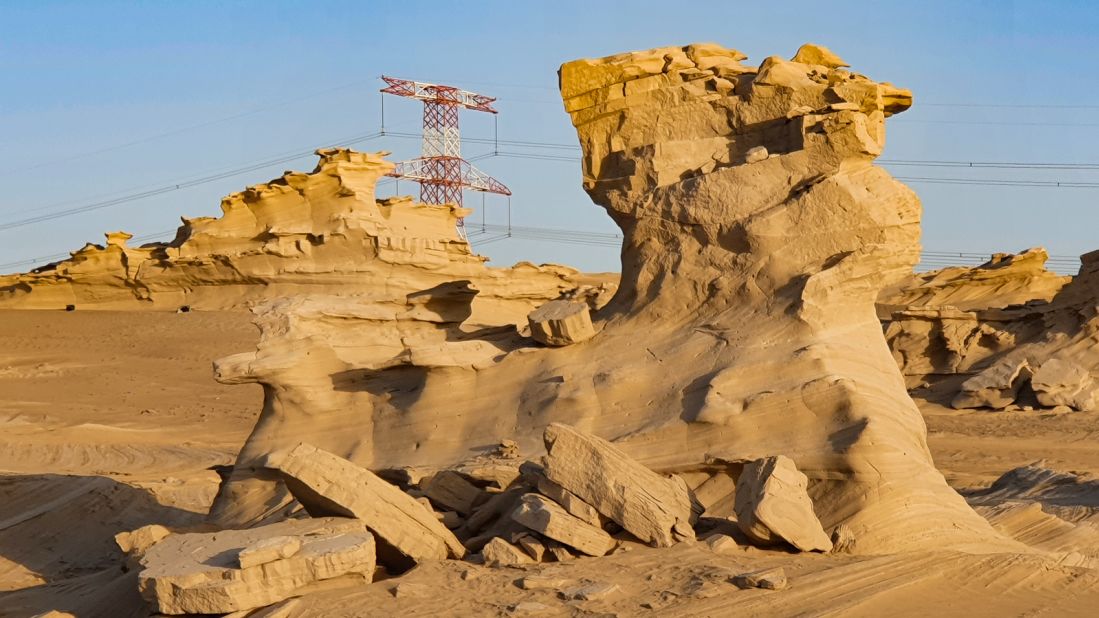 <strong>Power lines:</strong> The dune site is flanked by large electricity pylons, which add a striking modern dimension to the otherwise timeless desert scenes. 