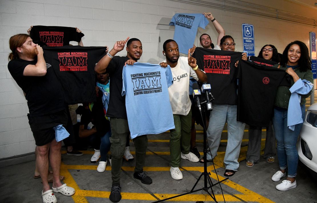 Workers at the Towson Town Center Apple hold their new union T-shirts on June 18, 2022, after their store employees decided to join the International Association of Machinists Union. Theirs is the first Apple store in the United States to vote for union representation. 