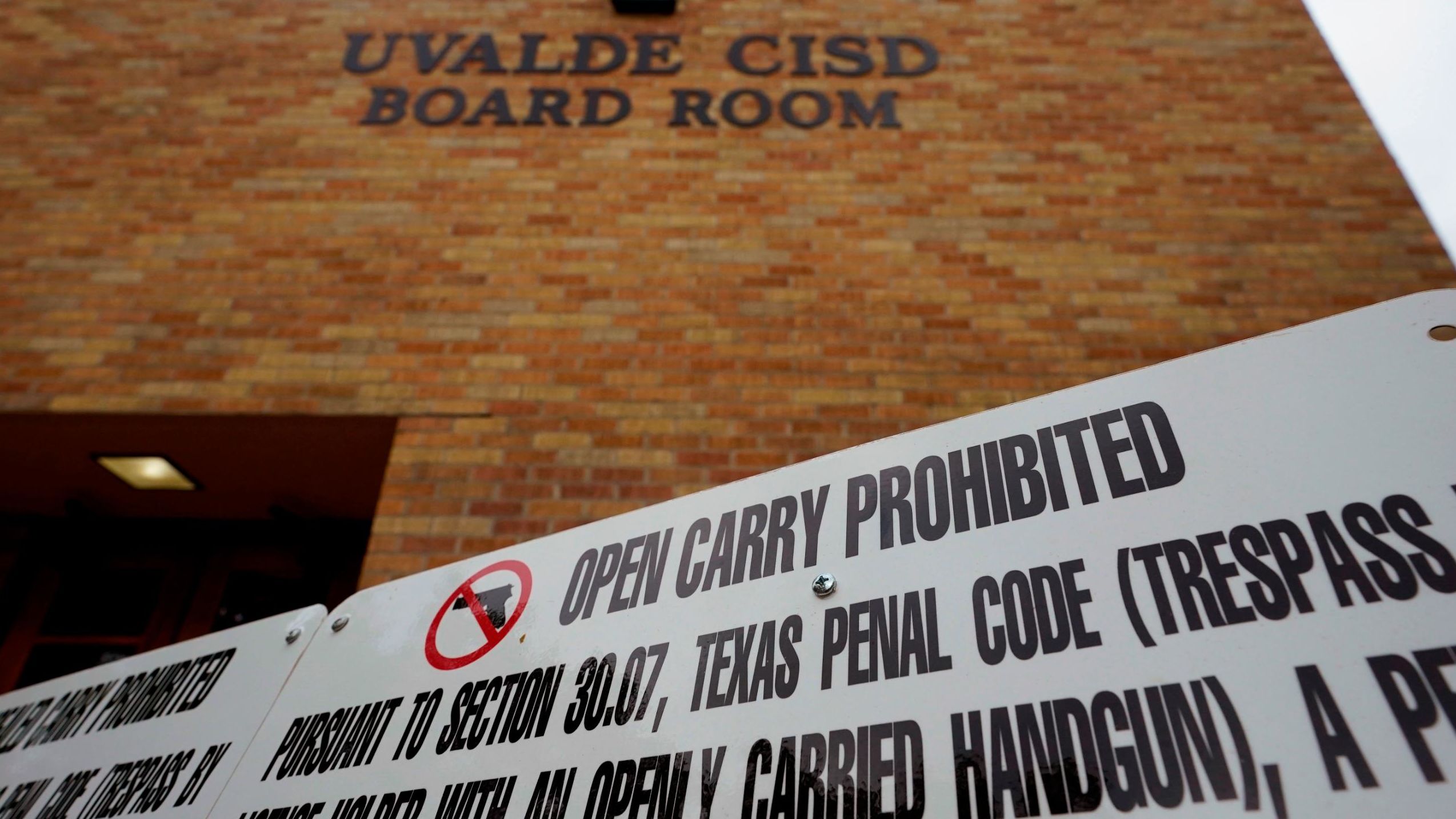 A sign prohibiting guns is displayed outside the Uvalde Consolidated Independent School District board room on  Thursday, June 9, 2022, in Uvalde, Texas.