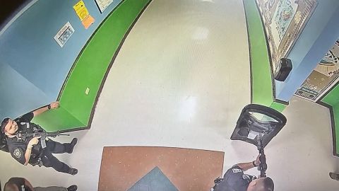 The image, obtained by the Austin-American Statesman, shows at least three officers in the hallway of Robb Elementary, one officer with what appears to be a tactical shield, two of the officers with rifles at 11:52 a.m, 19 minutes after the gunman entered the school.