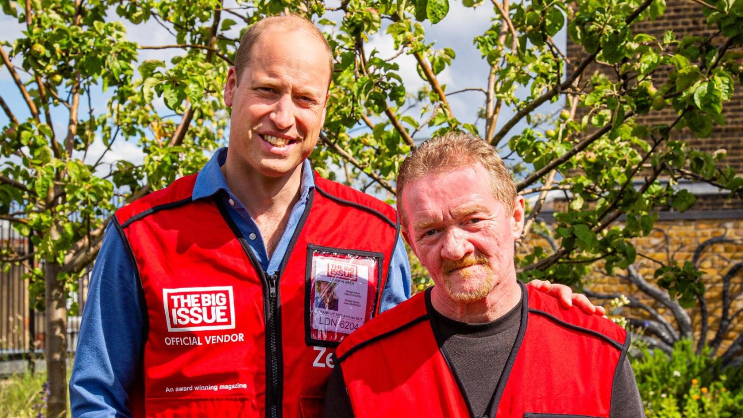 Britain's Prince William stands with Dave Martin, a vendor of The Big Issue magazine.