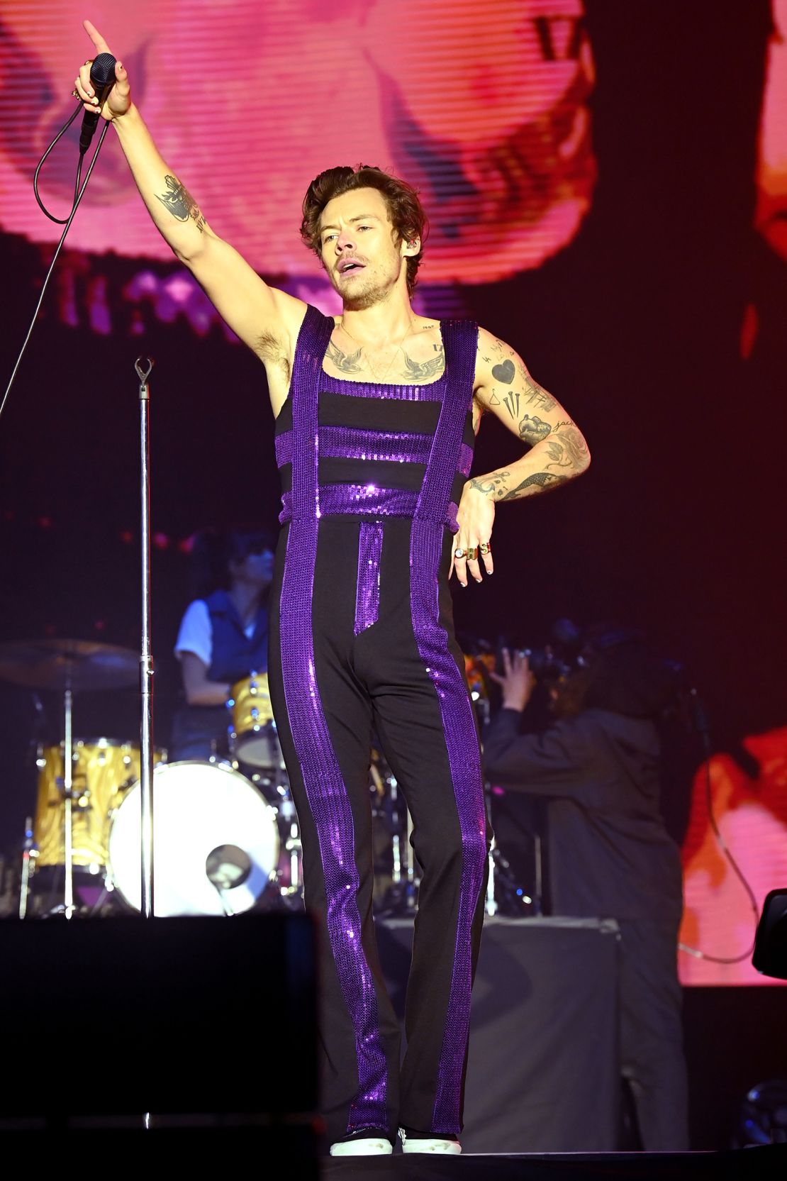Styles' on-stage wardrobe often includes a fitted jumpsuit, as pictured here performing at BBC Radio One's Big Weekend festival in 2022.