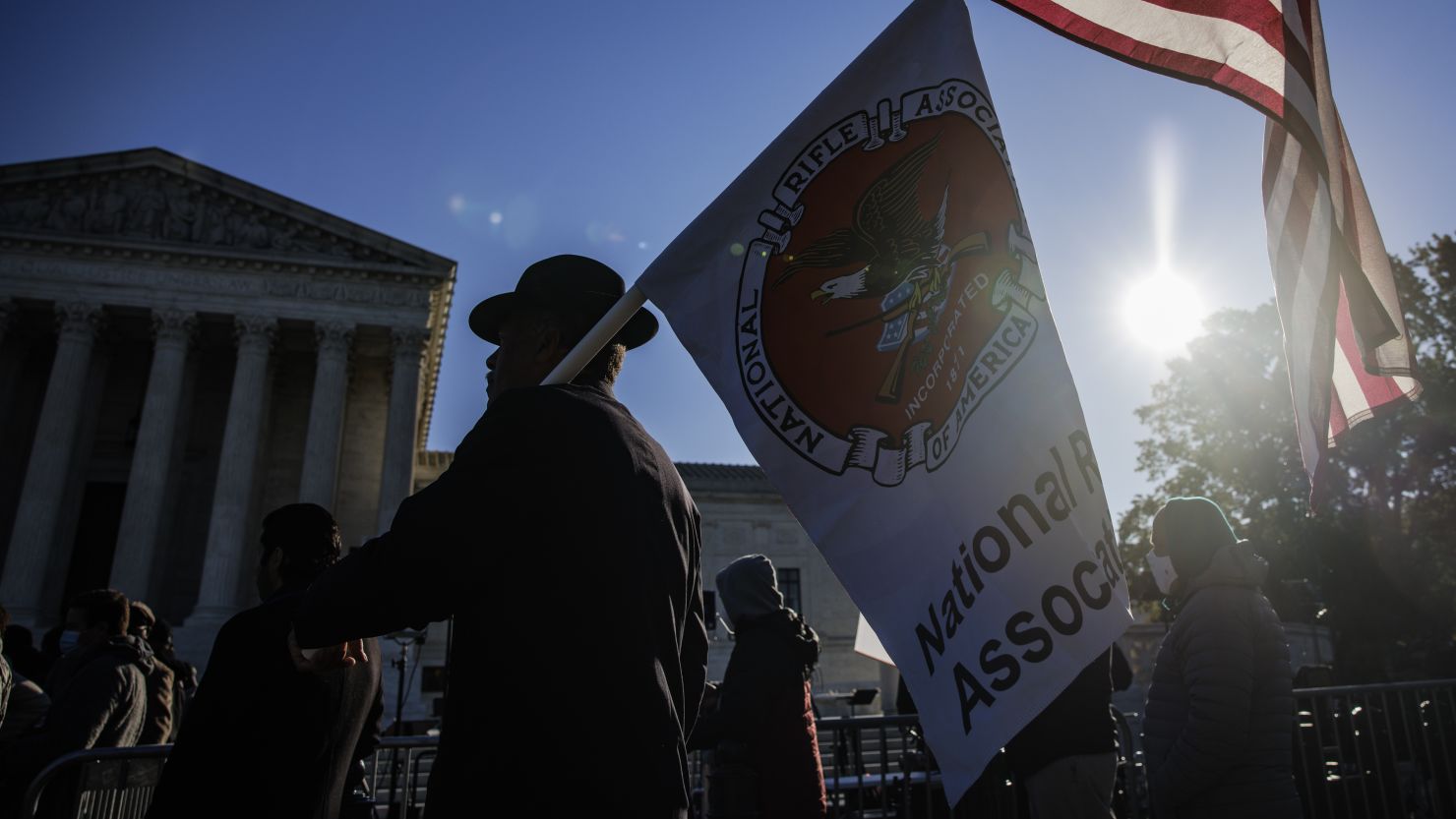 A Second Amendment demonstrator holds American and National Rifle Association flags outside the US Supreme Court 
