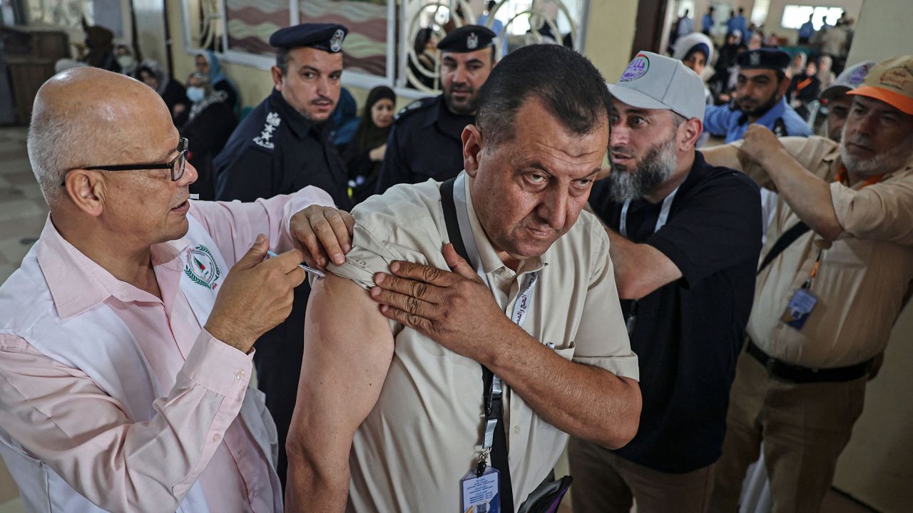 A Palestinian Muslim pilgrim gets a dose of a vaccine against Covid-19 at the Rafah border crossing with Egypt on June 21, as he heads to Saudi Arabia for the annual Hajj pilgrimage.