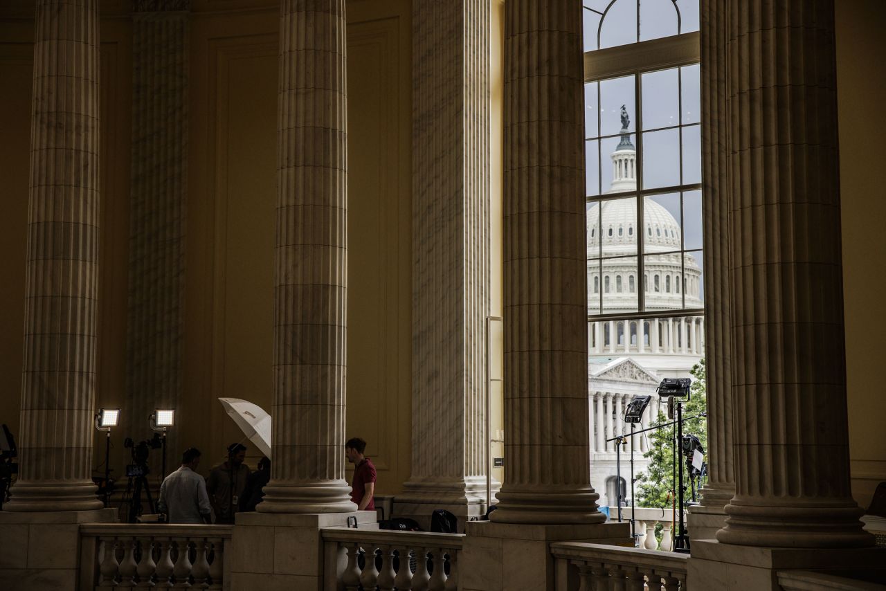 Members of the media work in the rotunda of the Cannon House Office Building outside the hearing on June 21.