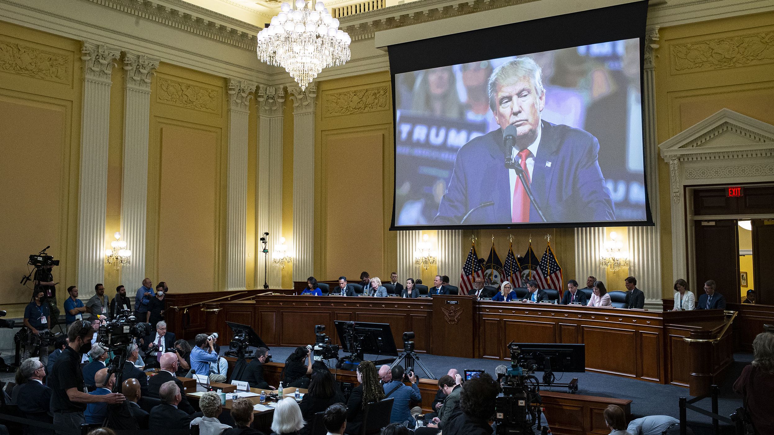 Video of Trump is seen over the committee during the hearing on June 21.