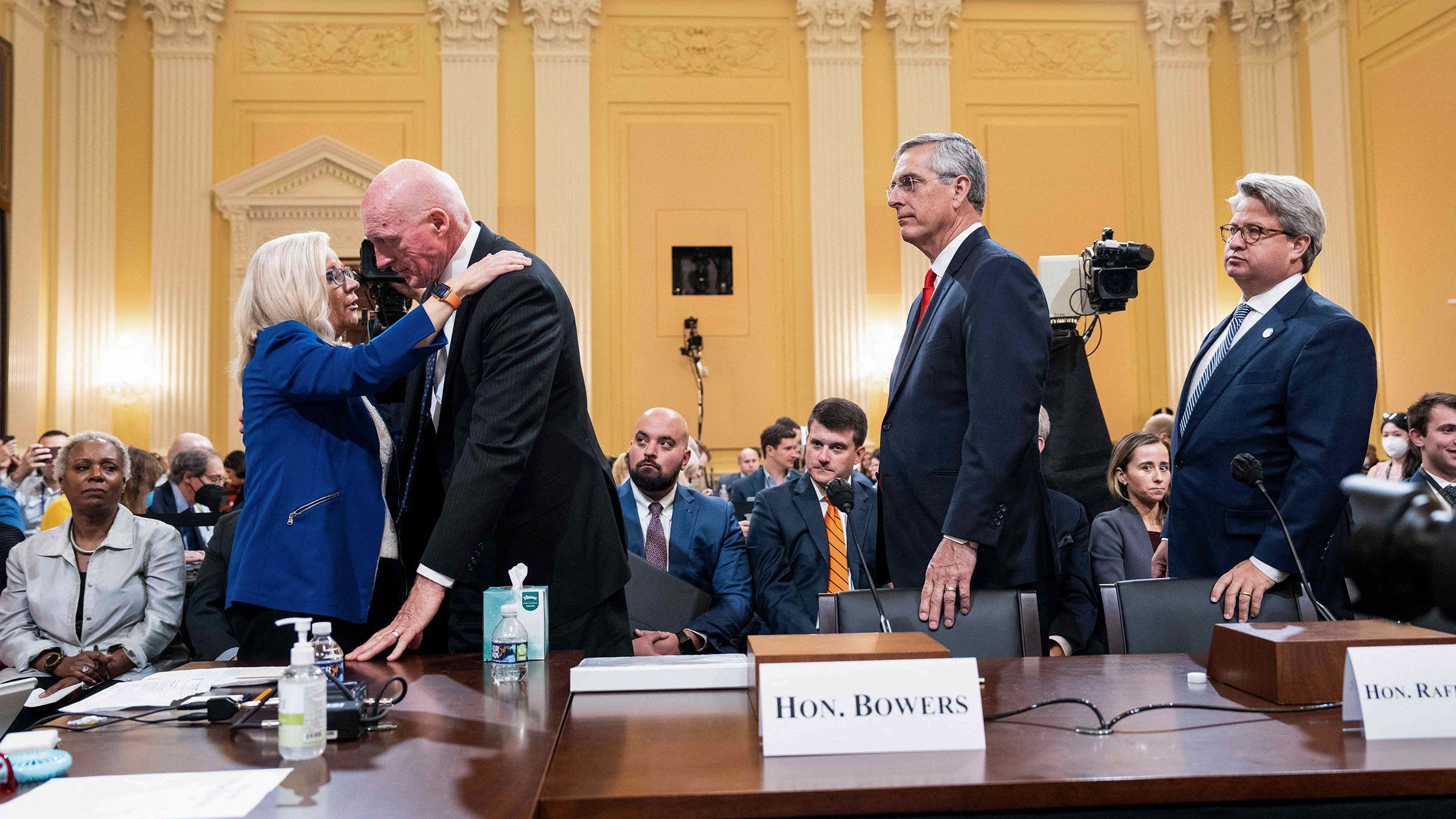 Bowers is hugged by Cheney after his testimony on June 21. Bowers, a Republican, defied a scheme to overturn the election results in his state, and <a href="index.php?page=&url=https%3A%2F%2Fwww.cnn.com%2Fpolitics%2Flive-news%2Fjanuary-6-hearings-june-21%2Fh_29dae2b5e7e4b560fa75d919562ec68e" target="_blank">he gave emotional testimony about the impact that had.</a> He described "disturbing" protests outside his home, and he read a passage from his personal journal about friends who had turned on him. 