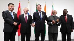TOPSHOT - (From left) Chinese President Xi Jinping, Russian President Vladimir Putin, Brazilian President Jair Bolsonaro, India's Prime Minister Narendra Modi and South African President Cyril Ramaphosa shake hands as they pose during a BRICS summit meeting at the G20 summit in Osaka on June 28, 2019. (Photo by Mikhail KLIMENTYEV / AFP)        (Photo credit should read MIKHAIL KLIMENTYEV/AFP via Getty Images)