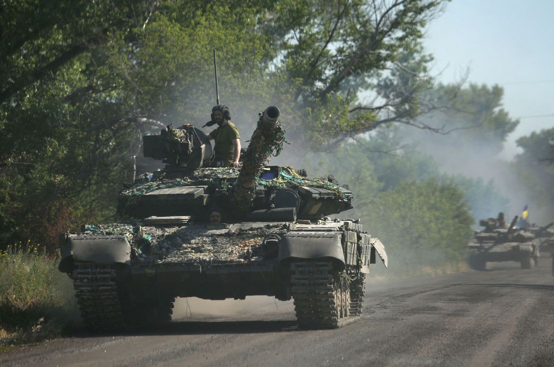 Ukrainian troops travel in armored vehicles on a road in the eastern Ukrainian region of Donbas on June 21, 2022.