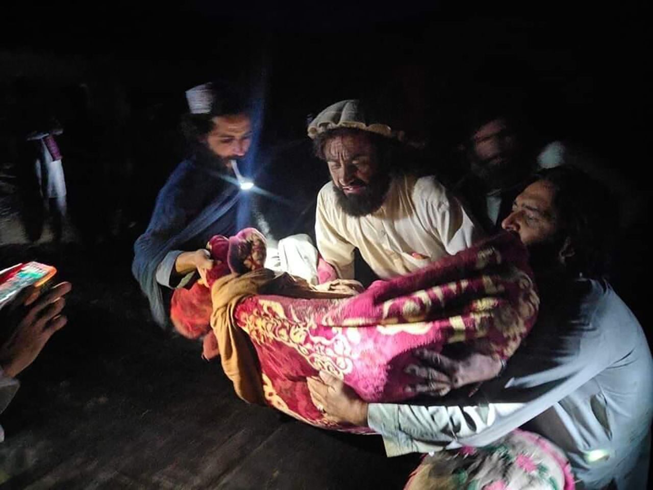 Afghans evacuate wounded people in the province of Paktika, eastern Afghanistan, on June 22.