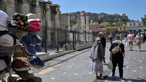 Tourists wearing face masks walk in Athens on June 1, when Greece dropped most of its Covid-19 restrictions.