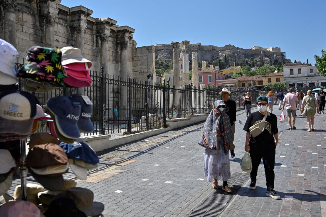 Tourists wearing face masks walk in Athens on June 1, when Greece dropped most of its Covid-19 restrictions.