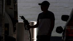 A customer holds a fuel nozzle at a gas station in San Francisco, California.