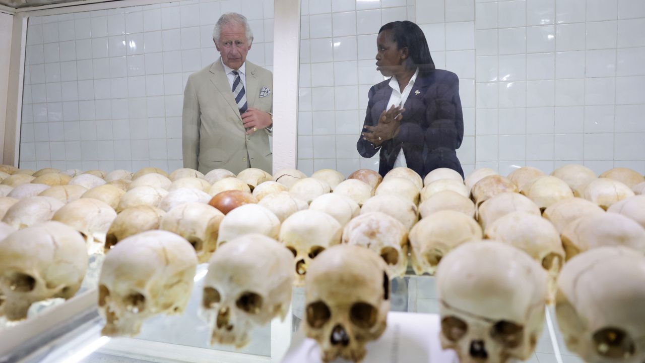 Prince Charles looks at the skulls of victims of the massacre.