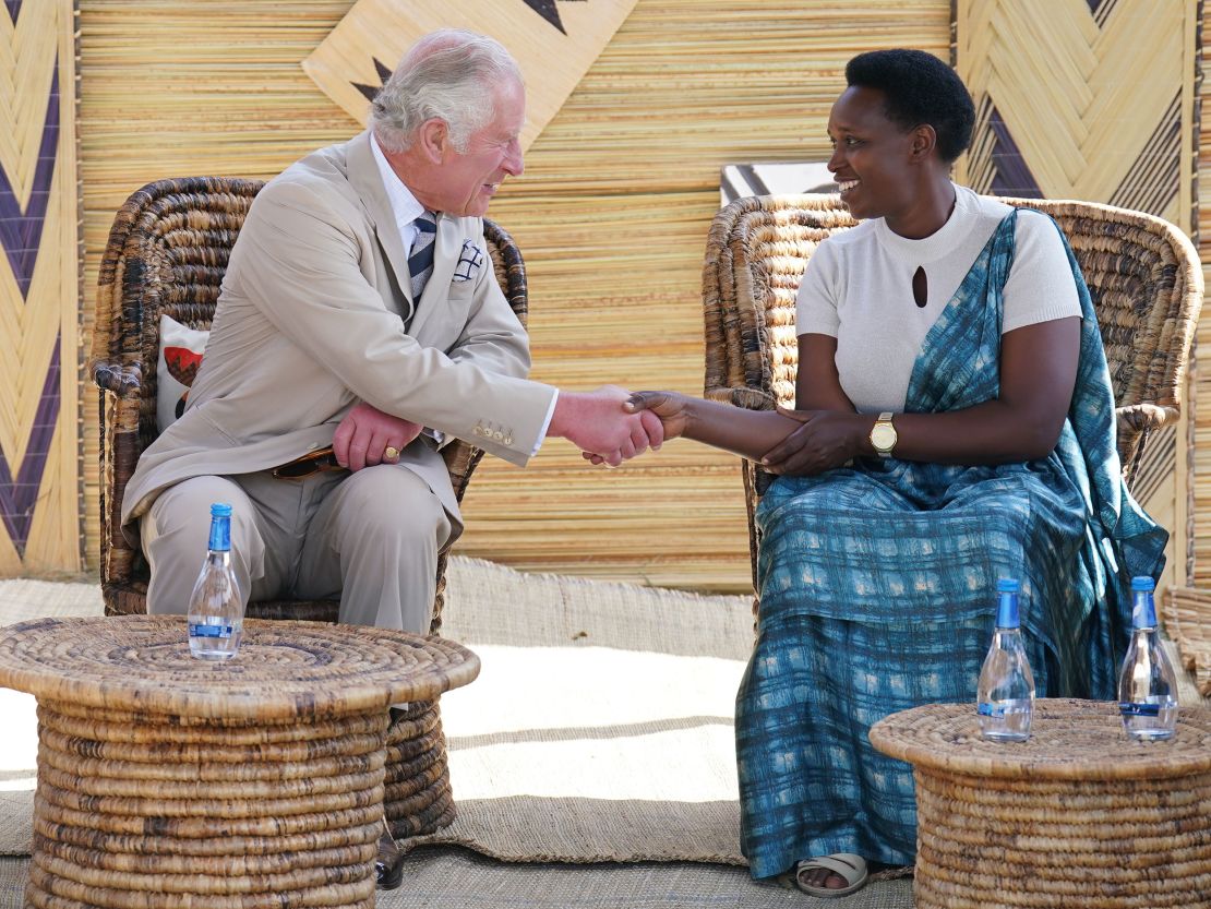 Prince Charles meeting a genocide survivor at the Mybo reconciliation village.