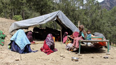 Afghan villagers sit outside a tent after their house was damaged by an earthquake in Spera, Khost province, on June 22.