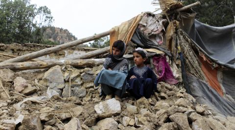 Children sit near their home that has been destroyed in an earthquake in the Spera District of southwest of the city of Khost, Afghanistan, on June 22.