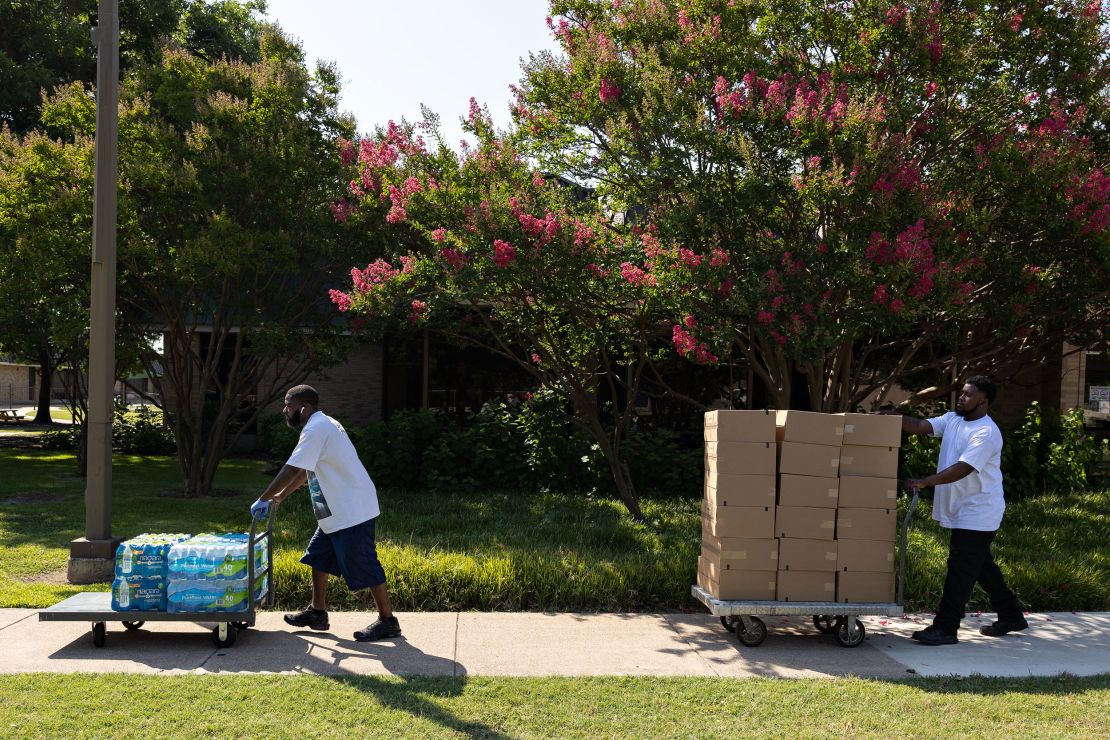 Volunteers cart water bottles and snacks to handout to residents at the Dr. Martin Luther King Jr. Community Center during a heatwave in Dallas, Texas,  on June 22, 2022.