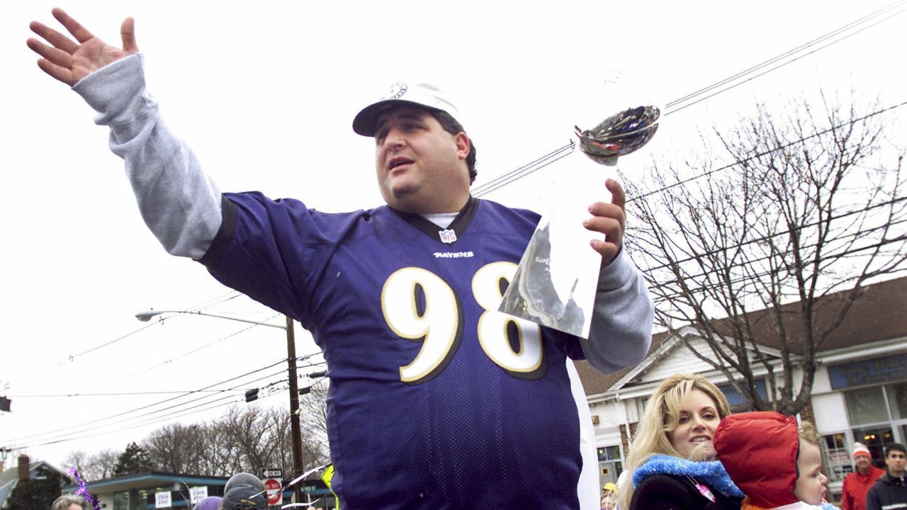 Tony Siragusa holds the trophy given to the Super Bowl winner during a parade in his hometown of Kenilworth, New Jersey, on March 4, 2001. 