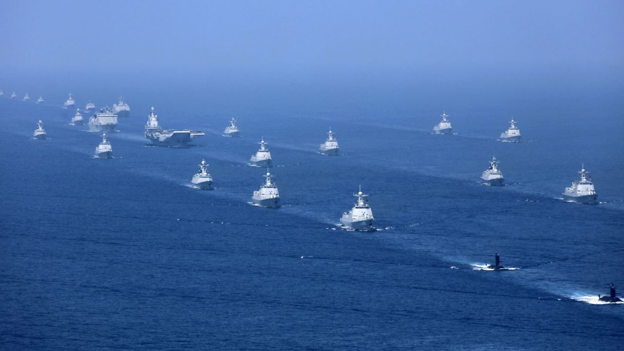 China's Liaoning aircraft carrier is accompanied by navy frigates and submarines during an exercise in the South China Sea.