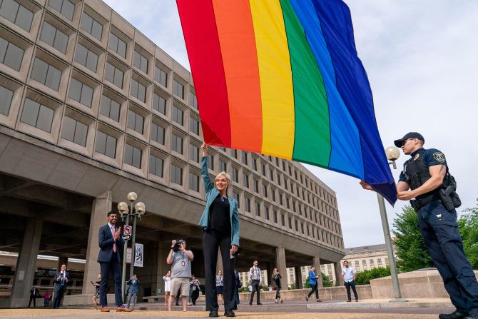 US Department of Energy Secretary Jennifer Granholm, center, helps raise the Progress Pride Flag outside the Department of Energy in Washington DC in June of 2021. To her left is Tarak Shah, who was the first person of color, first Indian-American and first openly LGBTQ person to serve as Chief of Staff for the D.O.E.