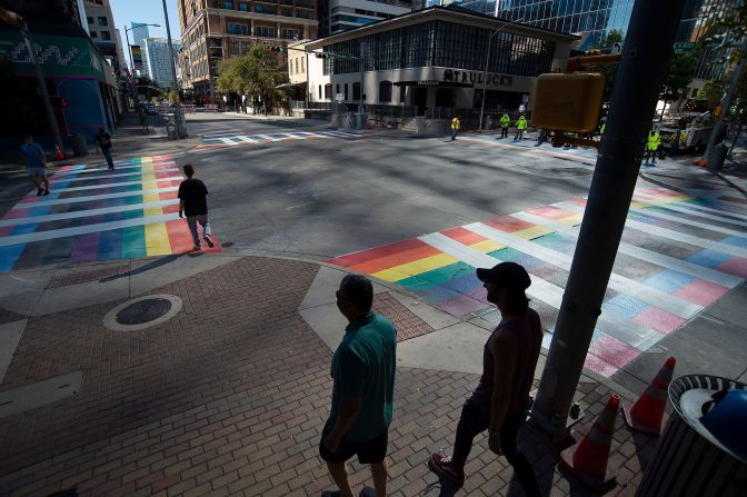 A creative crosswalk that resembles the Progressive Pride flag at an intersection in Austin, Texas, in commemoration of National Coming Out Day. 