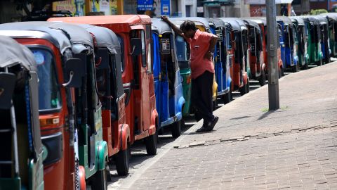 A driver looks on as hundreds of tuk-tuks wait for fuel in Colombo on June 20.