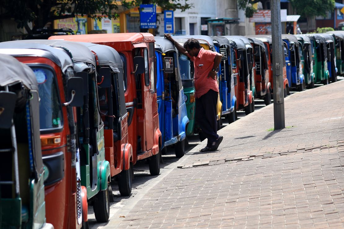 A driver looks on as hundreds of tuk-tuks wait for fuel in Colombo on June 20.