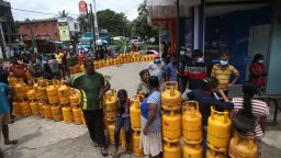 People wait to buy Liquefied Petroleum Gas (LPG) cylinders in Nawagamuwa near Colombo, Sri Lanka on June 18, 2022