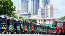 Autorickshaws are parked in a queue along a street to tank up petrol from a Ceylon petroleum corporation fuel station in Colombo on June 20, 2022.