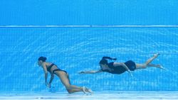 A member of Team USA (R) swims to recover USA's Anita Alvarez (L), from the bottom of the pool during an incident in the women's solo free artistic swimming finals, during the Budapest 2022 World Aquatics Championships at the Alfred Hajos Swimming Complex in Budapest on June 22, 2022.