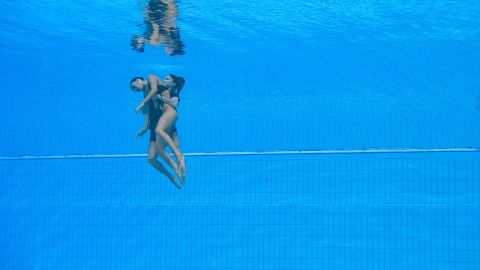Alvarez is brought to the surface of the pool. 