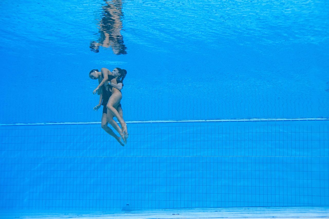 American artistic swimmer Anita Alvarez is rescued from the bottom of the pool by her coach, Andrea Fuentes, after her routine in the women's solo free artistic swimming finals at the 2022 FINA World Aquatics Championships in Budapest, Hungary, on June 22. 