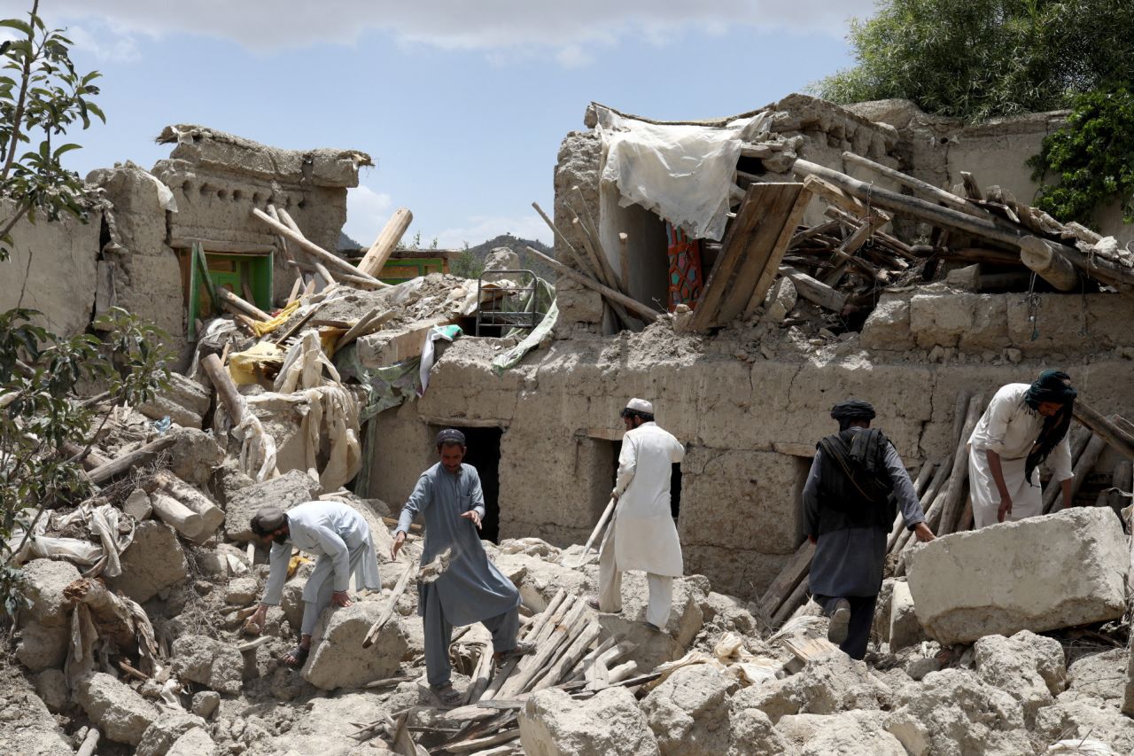 Afghan men search for survivors amidst the debris of a house that was destroyed by an earthquake in Gayan, Afghanistan, on June 23.