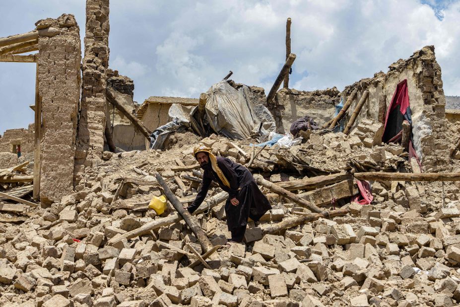An Afghan man looks for his belongings amid the ruins of a house damaged by an earthquake in Bernal district, Paktika province, on June 23.