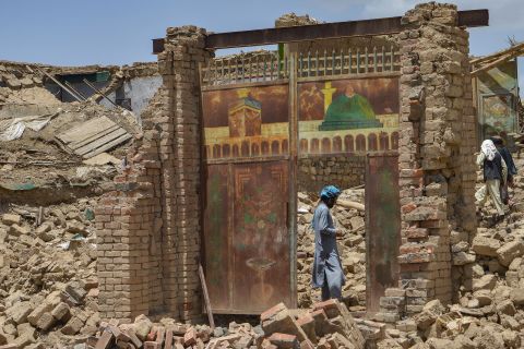 An Afghan man stands besides a door of a house damaged by an earthquake in Bernal district, Paktika province, on June 23.