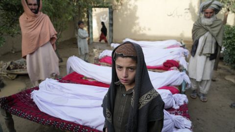 Men stand around the bodies of people killed in an earthquake in Gayan village, Paktika province, Afghanistan, June 23.