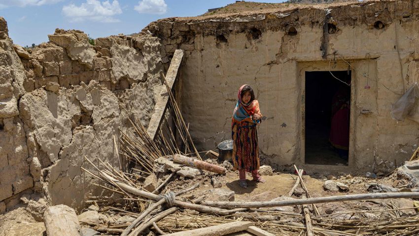 A child stands besides a house damaged by an earthquake in Bernal district, Paktika province, on June 23, 2022. - Desperate rescuers battled against the clock and heavy rain on June 23 to reach cut-off areas in eastern Afghanistan after a powerful earthquake killed at least 1,000 people and left thousands more homeless. (Photo by Ahmad SAHEL ARMAN / AFP) (Photo by AHMAD SAHEL ARMAN/AFP via Getty Images)